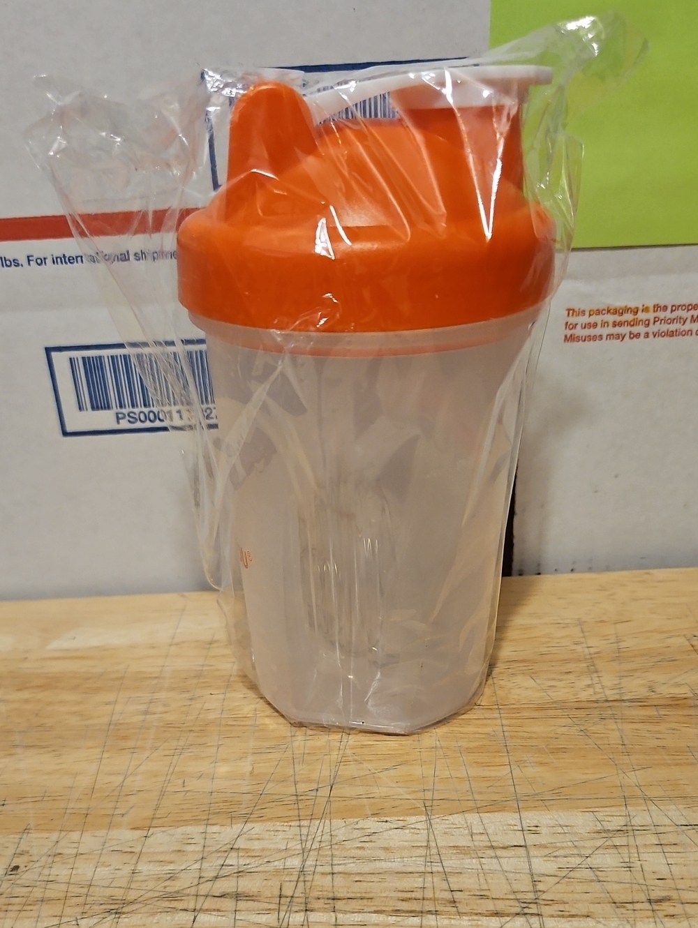 Clear Shaker Bottle with Bright Orange Lid